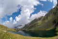 Balea lake and Balea Hotel in spring time with clouds Royalty Free Stock Photo